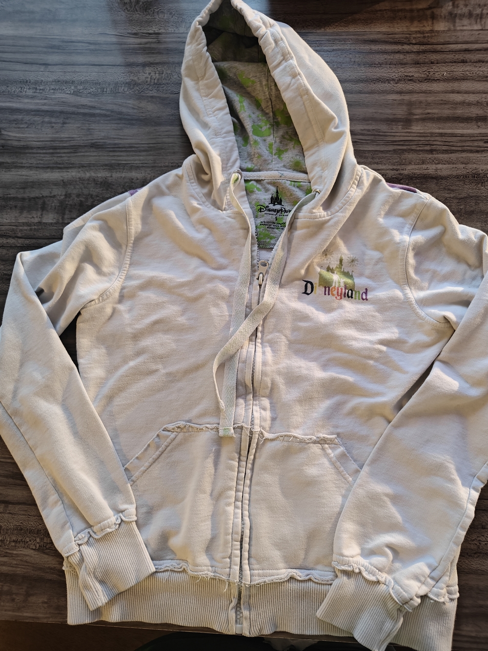 Disney Cream Hoodie with Green-Lined Hood and Subtle Multicolor Logo